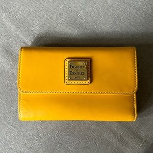 Dooney and Bourke tri-fold wallet in yellow leather.